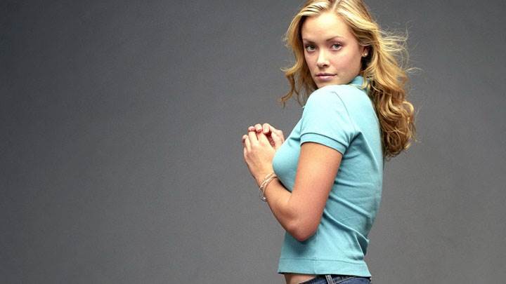 Kristanna Loken Smiling Side Pose In Blue Top And Blue Jeans
